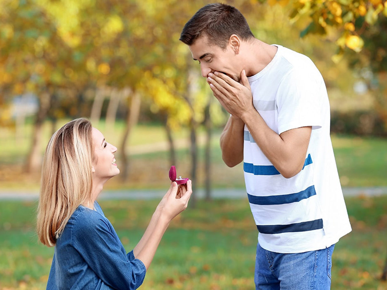 A woman is proposing to a man