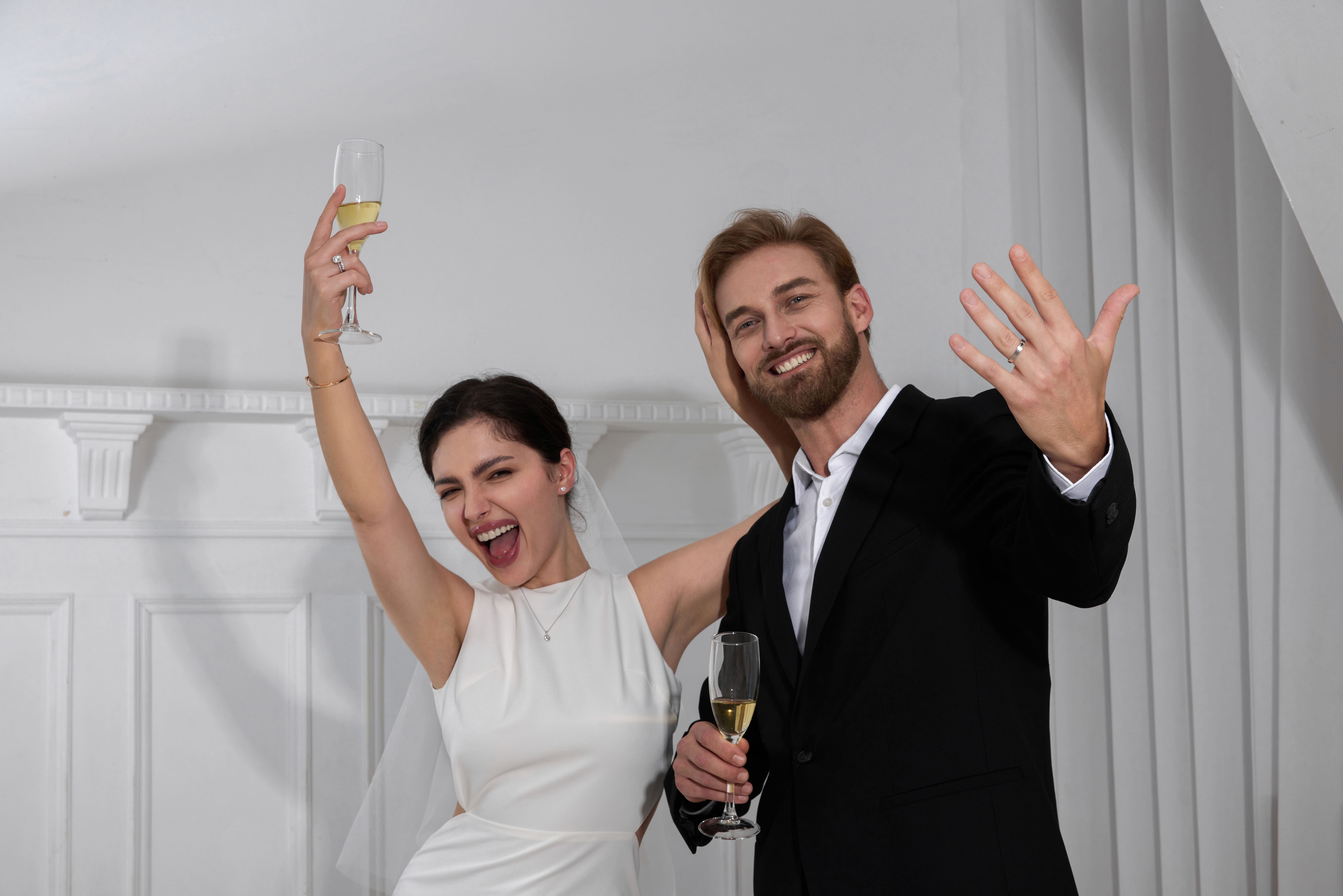 A man and a woman wearing  engagement ring is celebrating