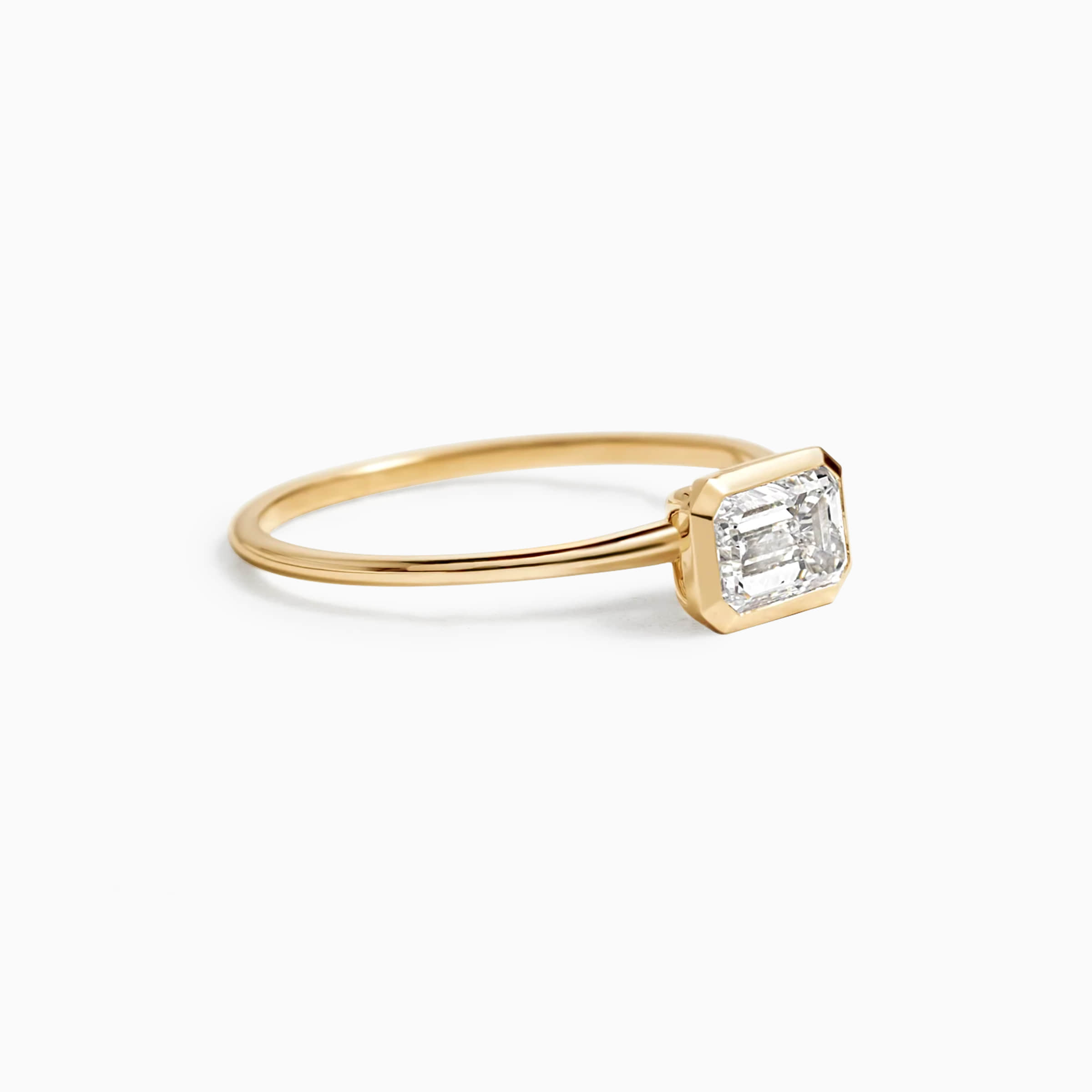 Darry Ring east west emerald cut ring yellow gold in side view